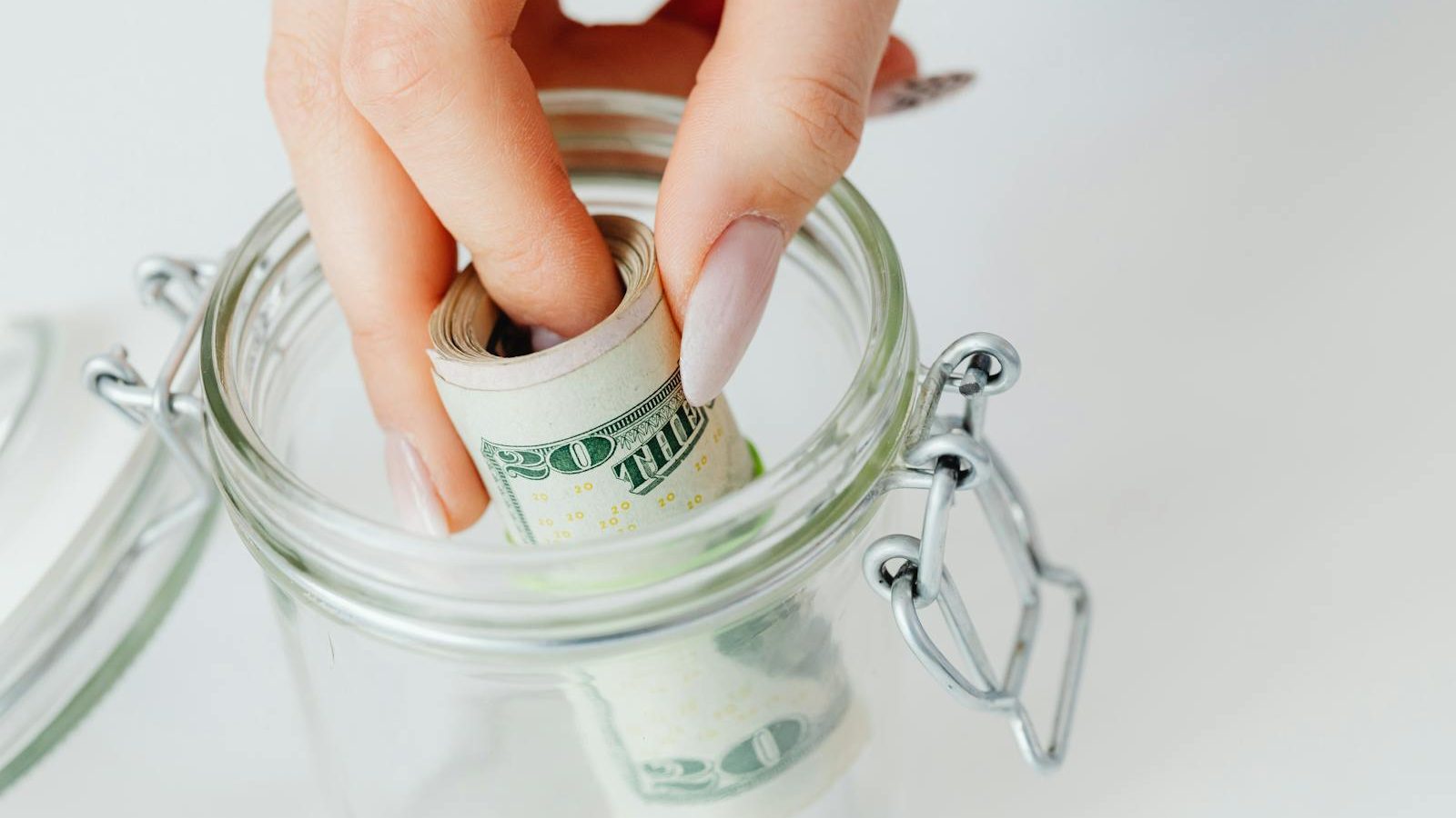 Close-Up Shot of a Person Saving Money in the Glass Jar, 10 Life-Changing Tips for Building an Emergency Fund