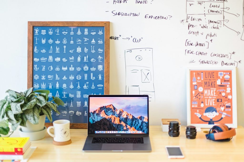 MacBook Pro on brown wooden table beside white mug, 5 Essential Leadership Skills Every Business Owner Needs