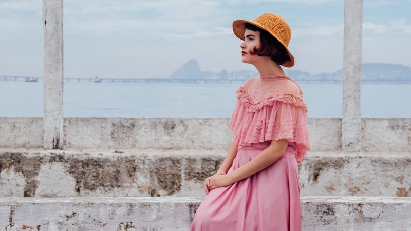 woman wearing pink dress standing next to white wall, 7 Secret Fashion Tricks Every Stylish Person Knows