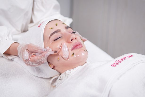 a woman getting a facial mask on her face