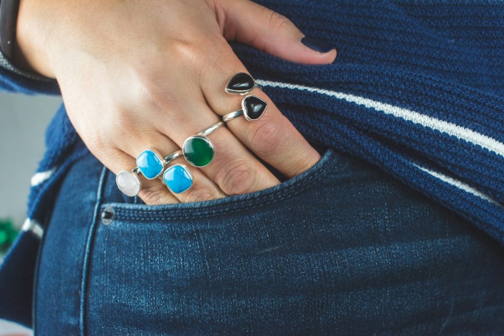 person wearing silver teal and green gemstone ring, 6 Must-Have Wardrobe Essentials for Every Woman