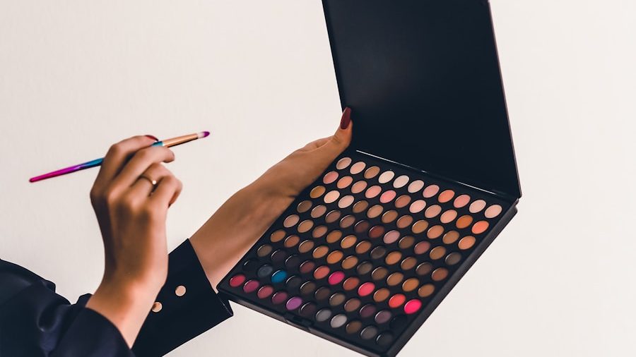 a person holding a makeup palette and a pencil, 10 Best Makeup Products You Need in Your Collection