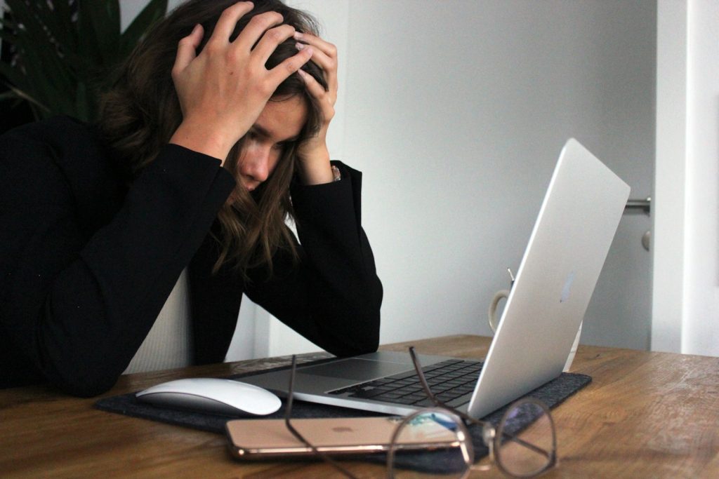 a woman sitting in front of a laptop computer Mental Health Resources Remote Management