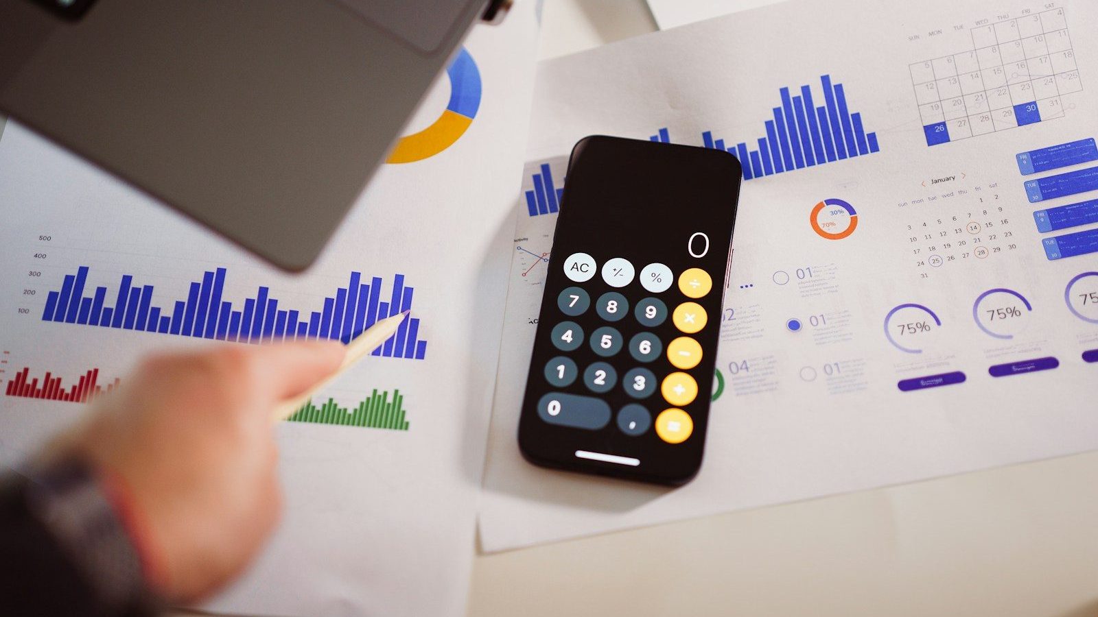 a calculator sitting on top of a table next to a laptop Calculate Minimum Viable Funding Crowdfunding Campaigns