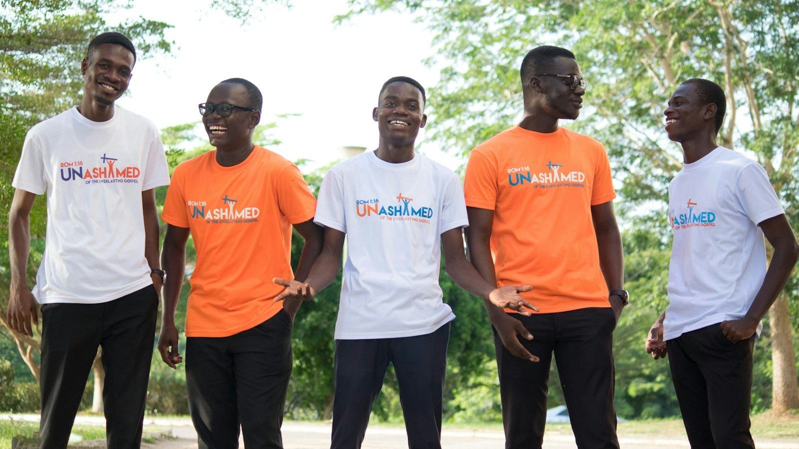 3 men in white crew neck t-shirts standing on green grass field during daytime Ideal Ambassadors Ambassador Programs
