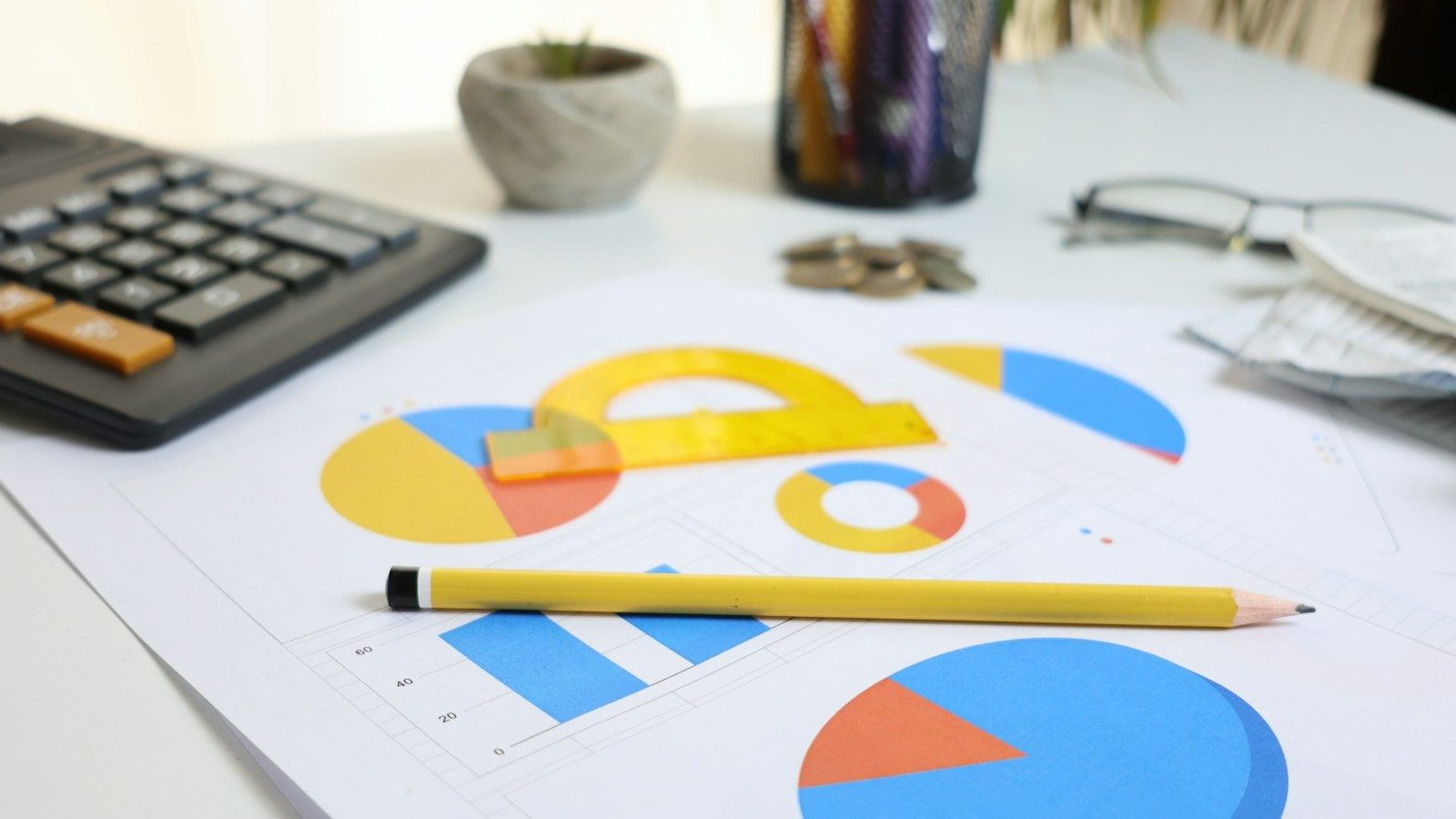 Desk with calculator, charts, and pencil Leadership in Budget Success Smart Budgeting