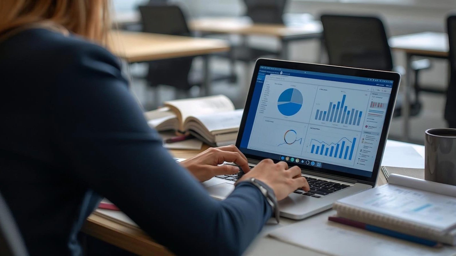 Woman working on laptop with charts and graphs. Financial Performance Smart Budgeting