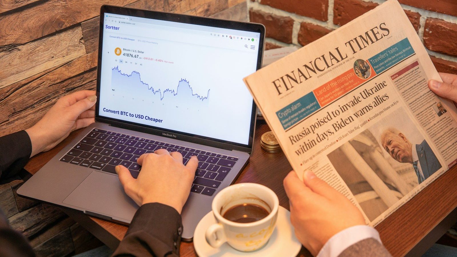 a person sitting at a table with a laptop and a cup of coffee Financial Awareness Hidden Fees in Contracts