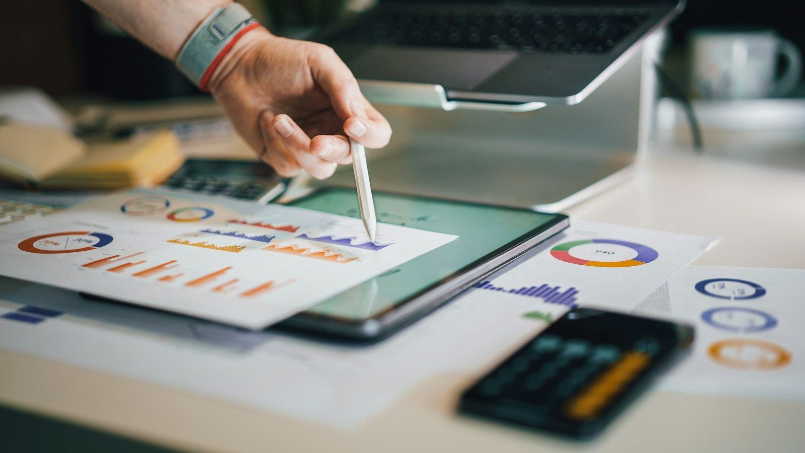 person using stylus on tablet with charts High Costs Right Choice