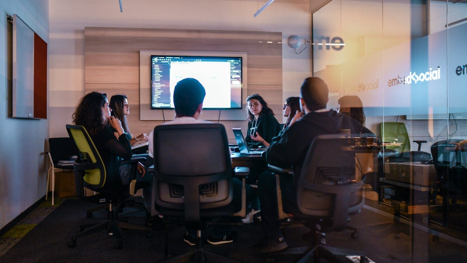 a group of people sitting in chairs in front of a projector screen Scaling Your E-Commerce Team