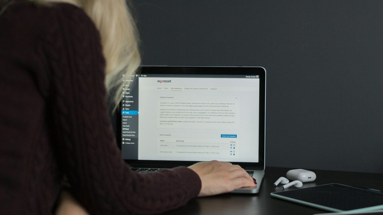 woman in black sweater using macbook pro Recovery Emails Cart Abandonment Rates
