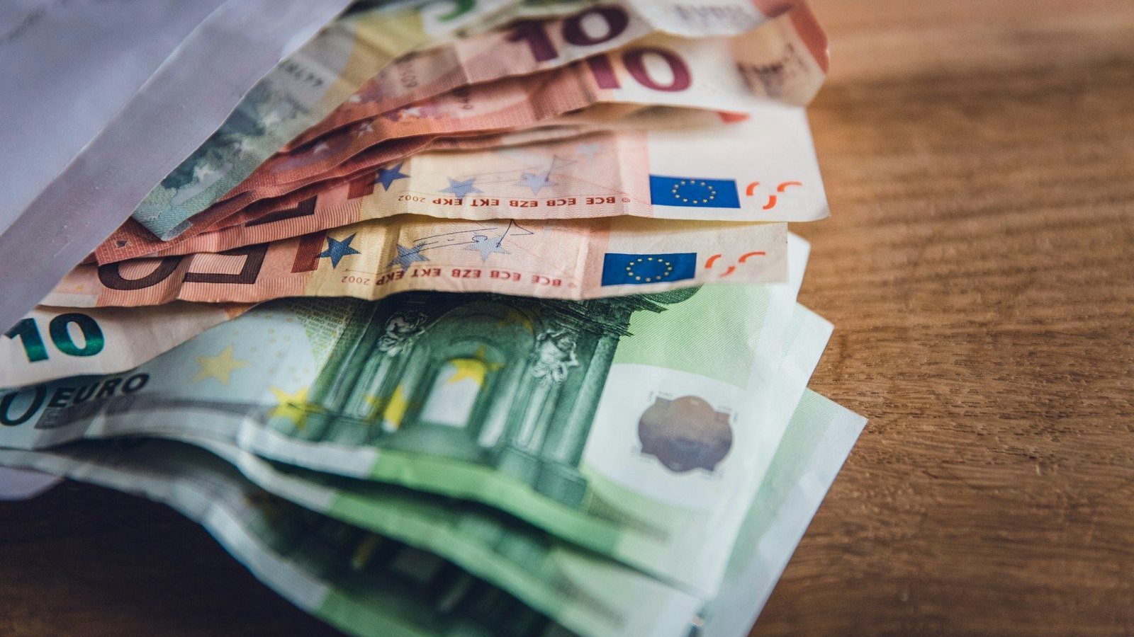 euro banknote collection on wooden surface Currency Conversion Global Shoppers