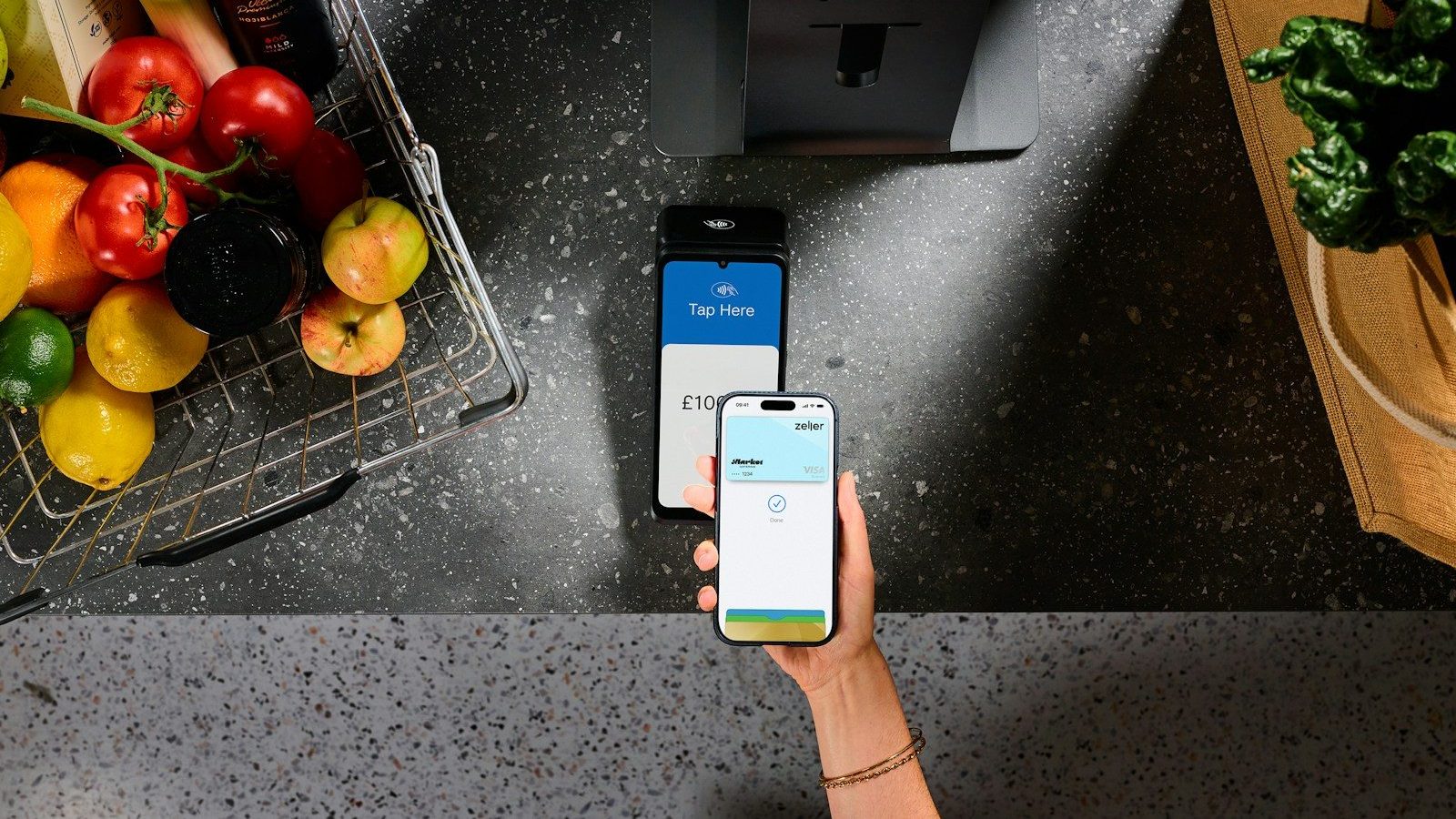 A person using a smartphone to pay at a contactless terminal near groceries QR Code Payments Emerging Payment Options