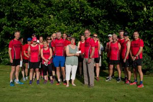 Members of Stone Master Marathoners join John Haine to hand over the £500 cheque