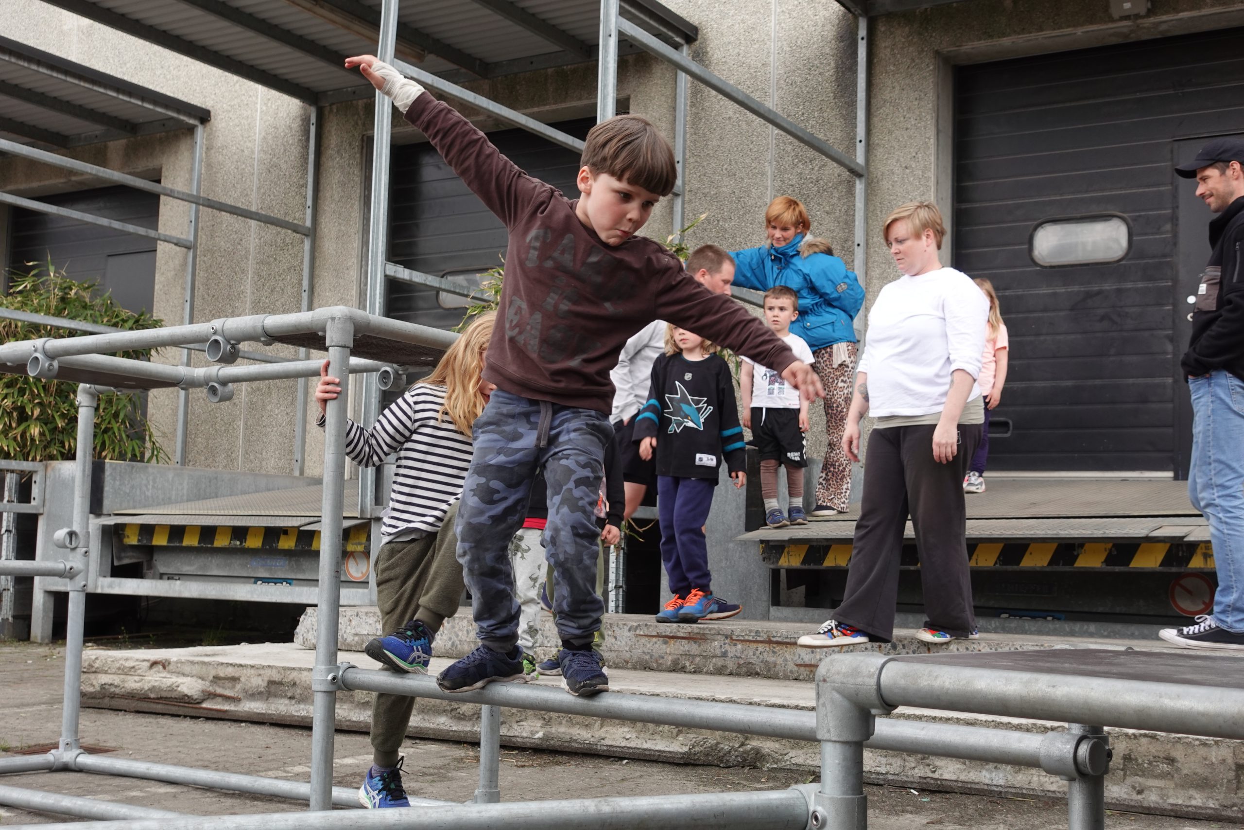 Parkour børn i Kbh, der står på rails og udfører parkour med andre børn