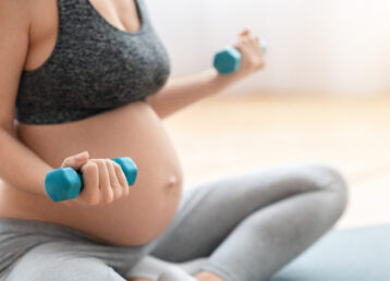Cropped,Shot,Of,Unrecognizable,Pregnant,Woman,Training,With,Dumbbells,At Cropped,Shot,Of,Unrecognizable,Pregnant,Woman,Training,With,Dumbbells,At
