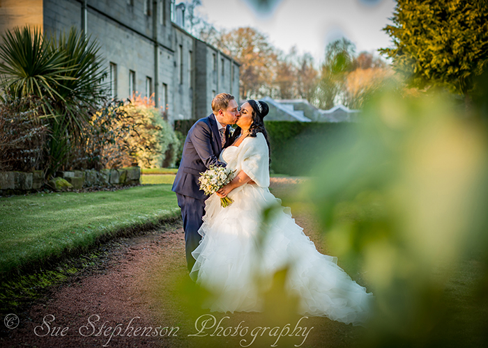 bride groom through leaves