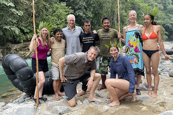 group of people standing in the jungle who has been trekking with Sumatra Orangutan Trekking