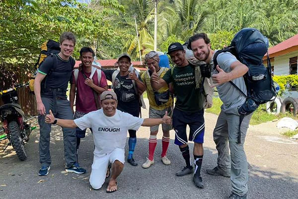 Group of people standing in Bukit Lawang before starting their jungle trek