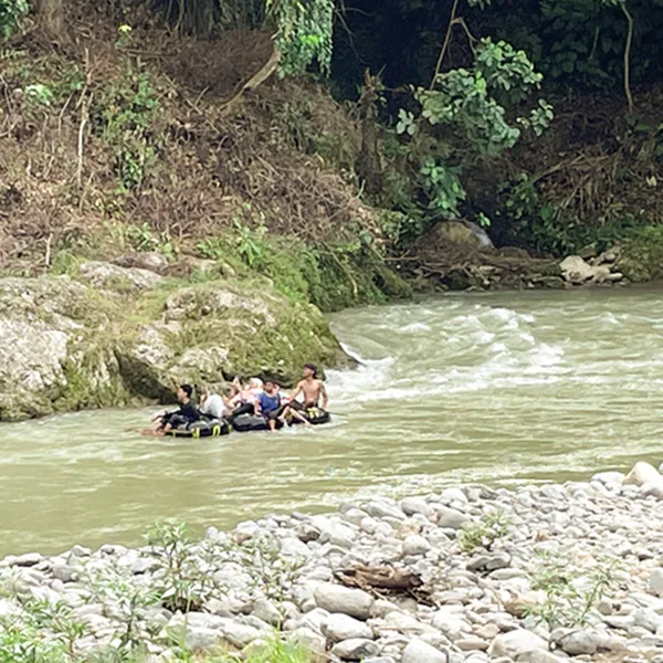 People are jungle river rafting in Bukit Lawang river
