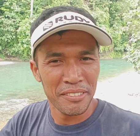 Portrait picture of Ongat with the jungle as background