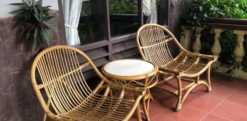 two bamboo relaxing chairs outside the hotel room