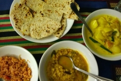 Roti, coconut sambol, potato curry and dal