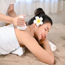 top-view-asian-woman-lying-massage-table-receiving-body-massage-with-spa-herbal-ball-less