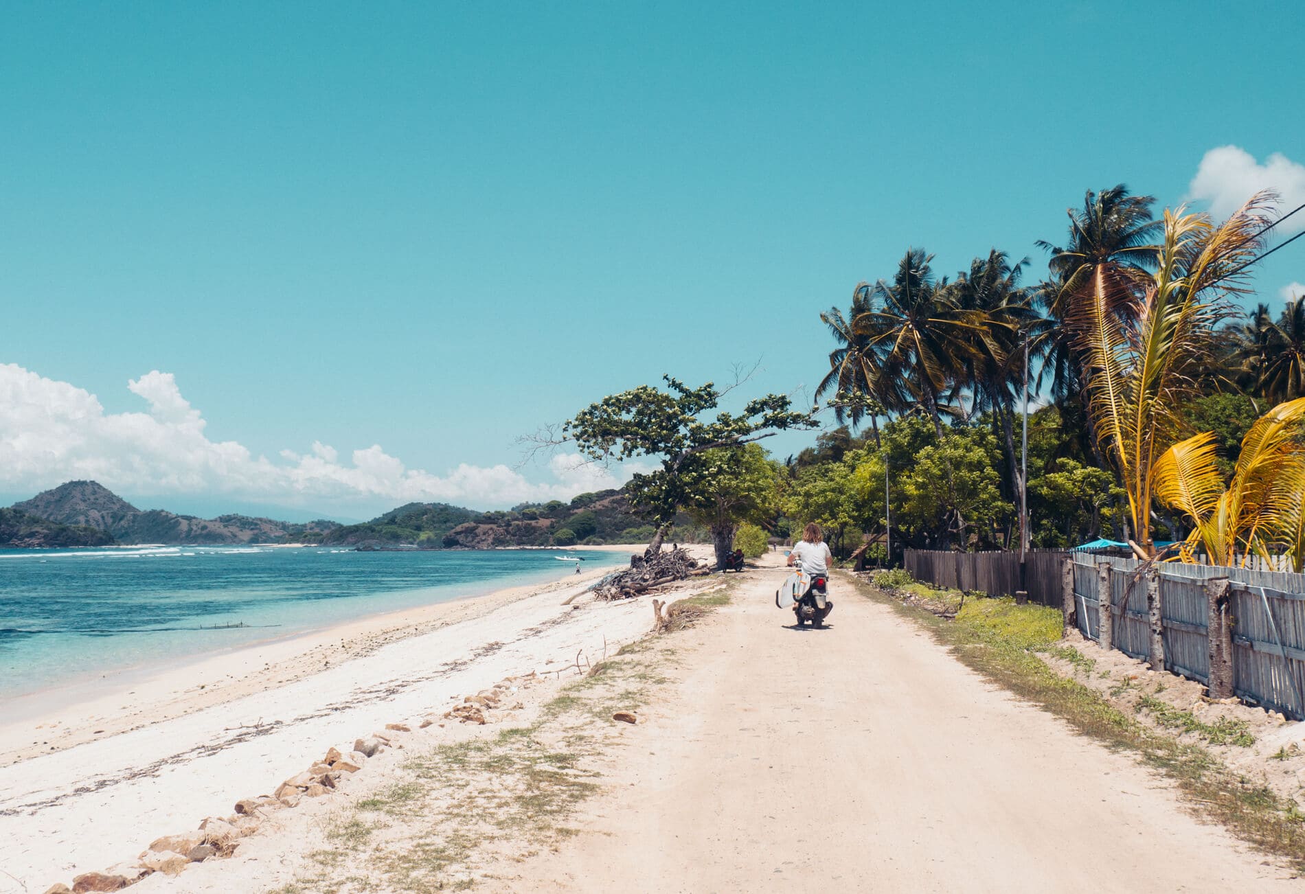 Surfer at Kertasari Beach, Whales & Waves Resort in Sumbawa, Indonesia - The most amazing place I've ever been