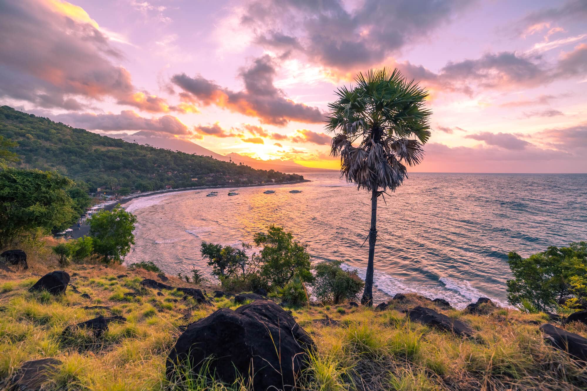 Where to stay in Bali: A complete guide to the different areas on the island - Pink and yellow sunset over Jemeluk Bay in Amed