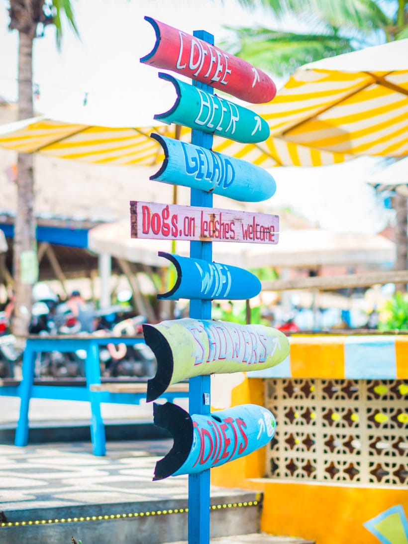Colorful signs at Old Man's beer garden right on Batu Bolong Beach in Canggu, a must on any two weeks Bali itinerary.