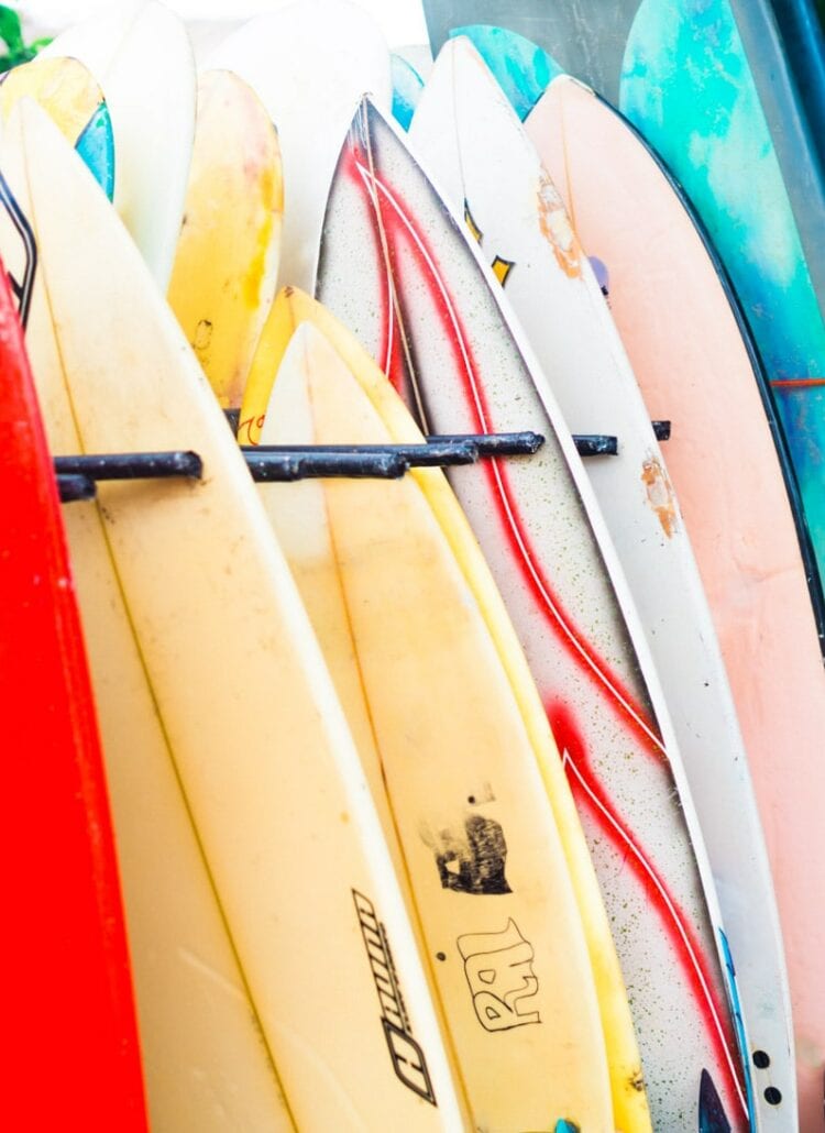 Close up of colorful surfboards, red, yellow, pink and turquoise, at Batu Bolong Beach in Canggu, Bali.