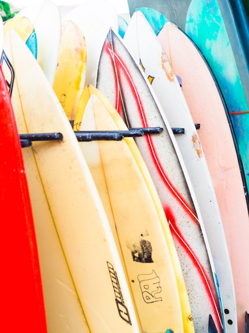 Close up of colorful surfboards, red, yellow, pink and turquoise, at Batu Bolong Beach in Canggu, Bali.