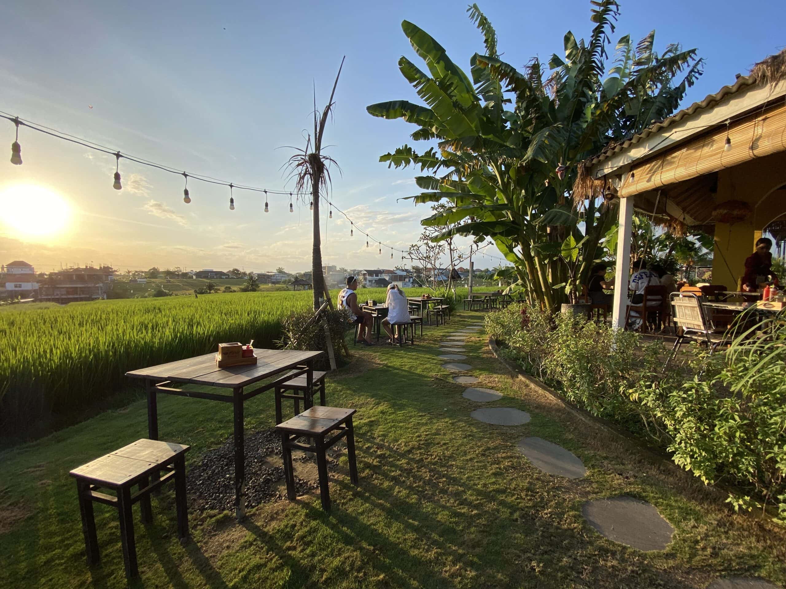 Empty table outside HoiAn restaurant in Echo Beach Canggu, right before the sun setting over the rice fields.