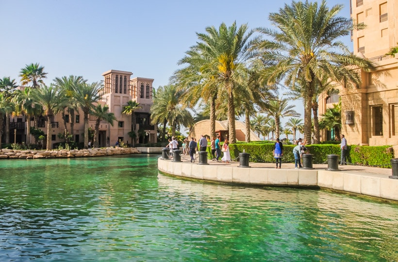 Green canal and palm tree lined boardwalk in beautiful Souk Madinat, a must during your 2 days in Dubai