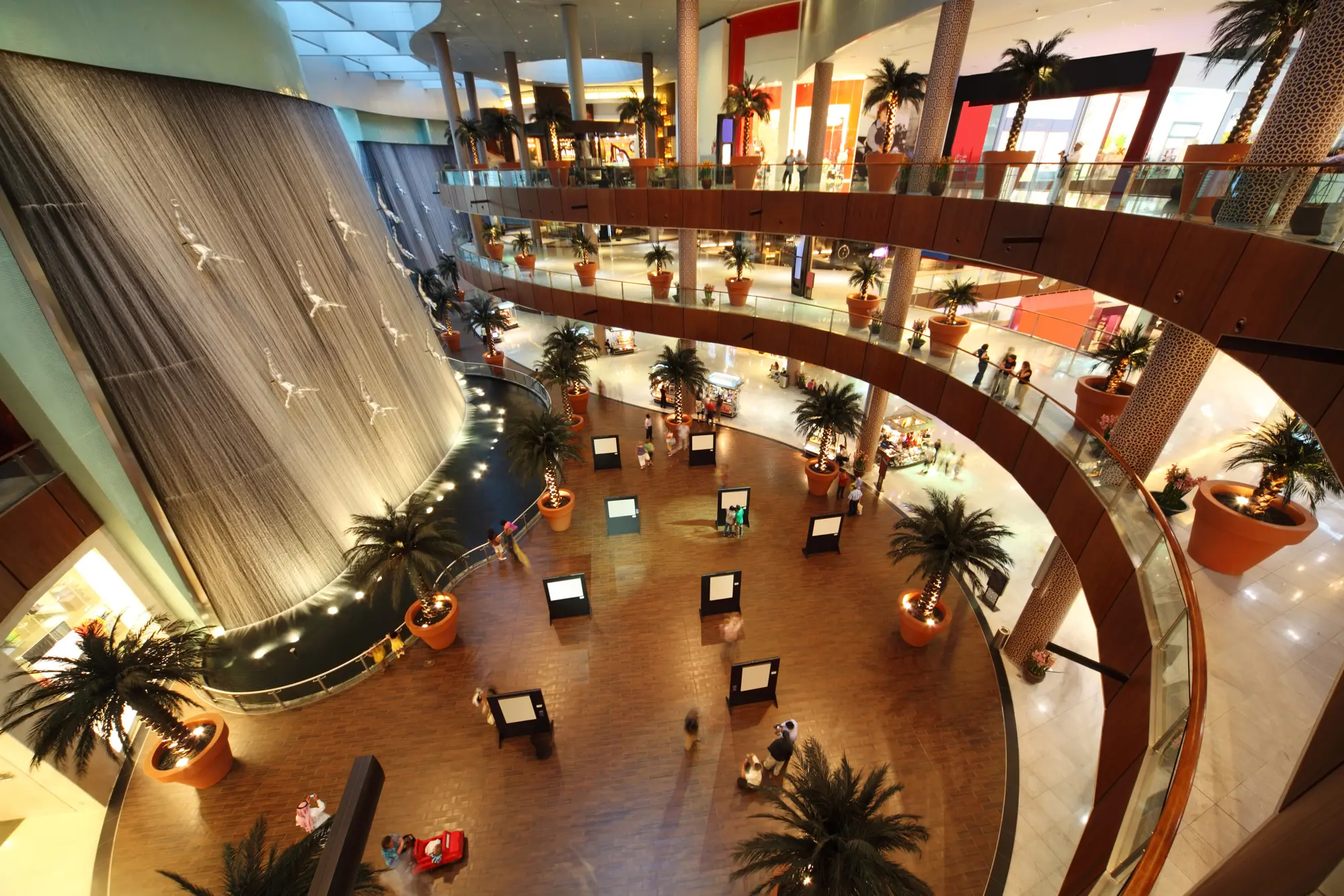 Art installation with figures diving down a waterfall inside the massive Dubai Mall, a must-see during your two day Dubai itinerary.