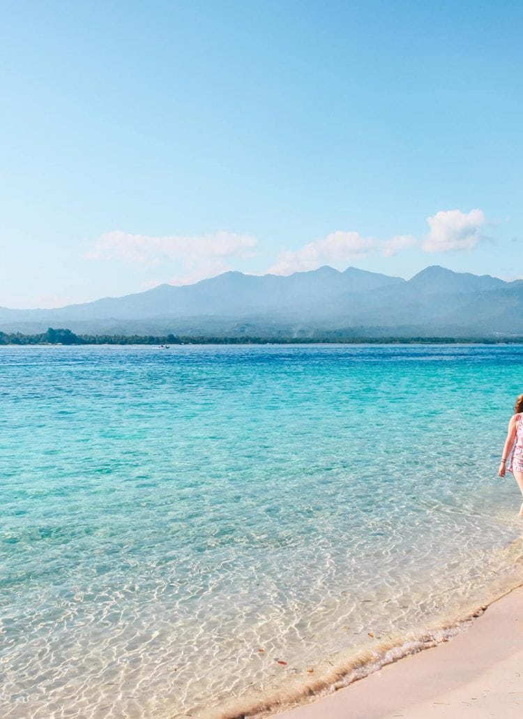 Walking in the turquoise water of Gili Air - One of the three gorgeous Gili Islands outside Lombok, Indonesia