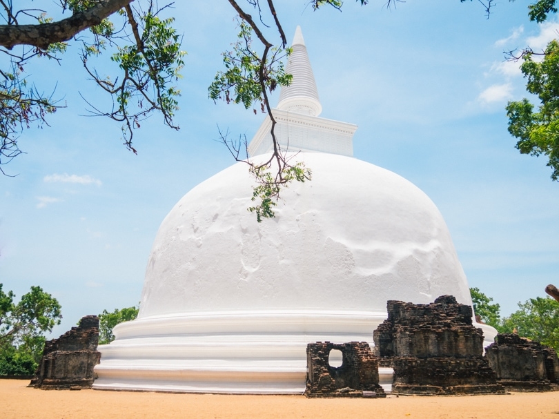 White stupa Kiri Vehera set against a blue sku in the incredible ancient city of Polonnaruwa, Sri Lanka.