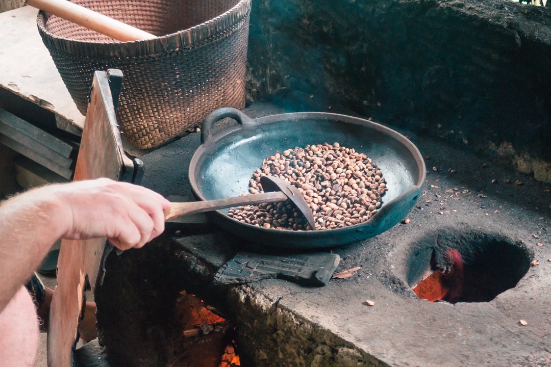 Toasting coffee beans on a plantation in the Kintamani Region during our cycling tour in Bali