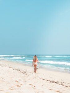 Girl walking along Nyang Nyang Beach in Uluwatu on a sunny day