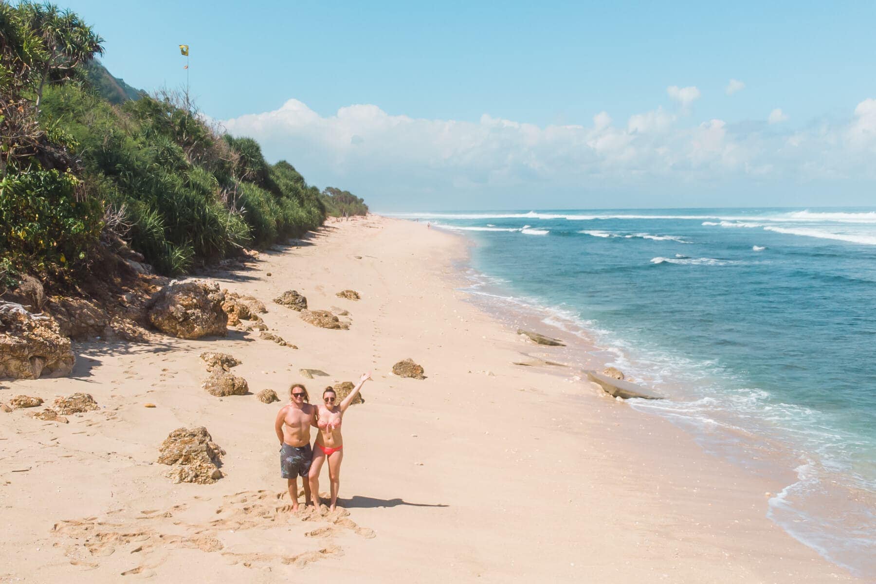 Drone photo of a couple on the empty Nyang Nyang beach in Uluwatu, Bali