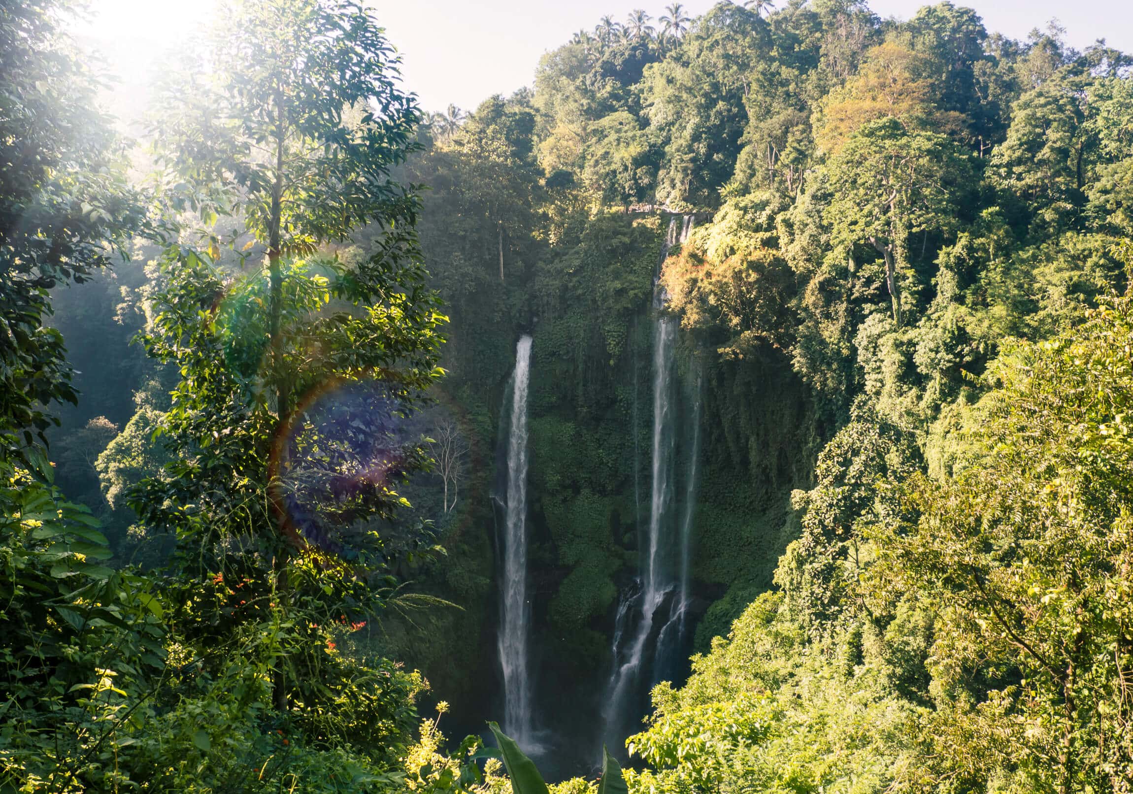 Sekumpul Waterfall in Bali seen from the upper viewpoint on a sunny day