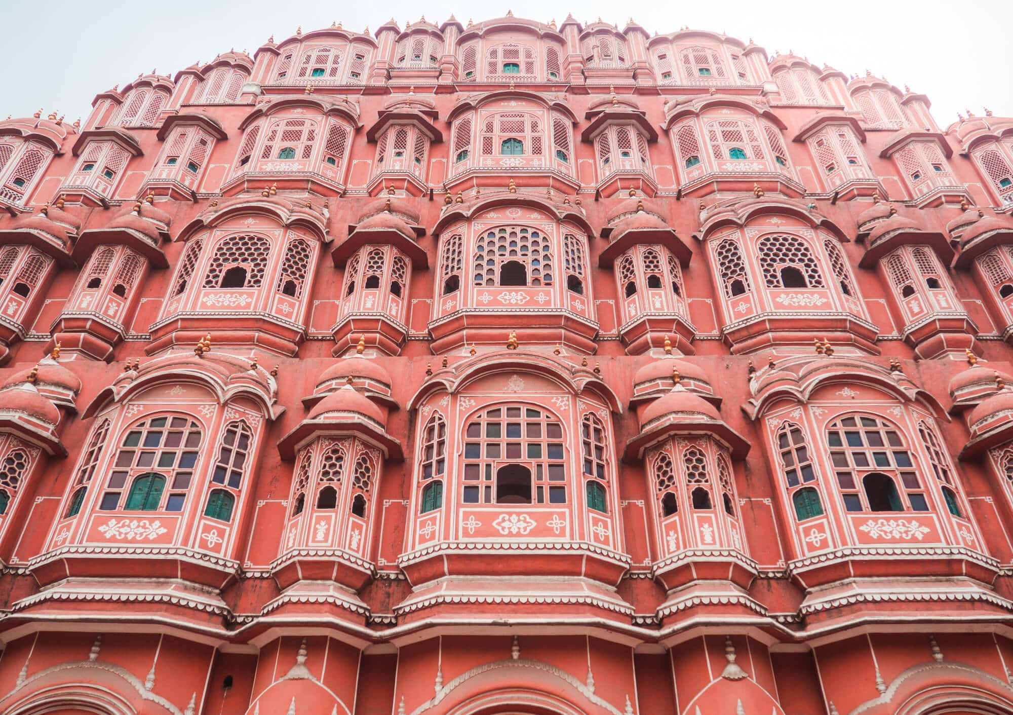 Hawa Mahal, the most stunning pink building in Jaipur, complete with 953 windows. A must on any 2-day Jaipur itinerary.