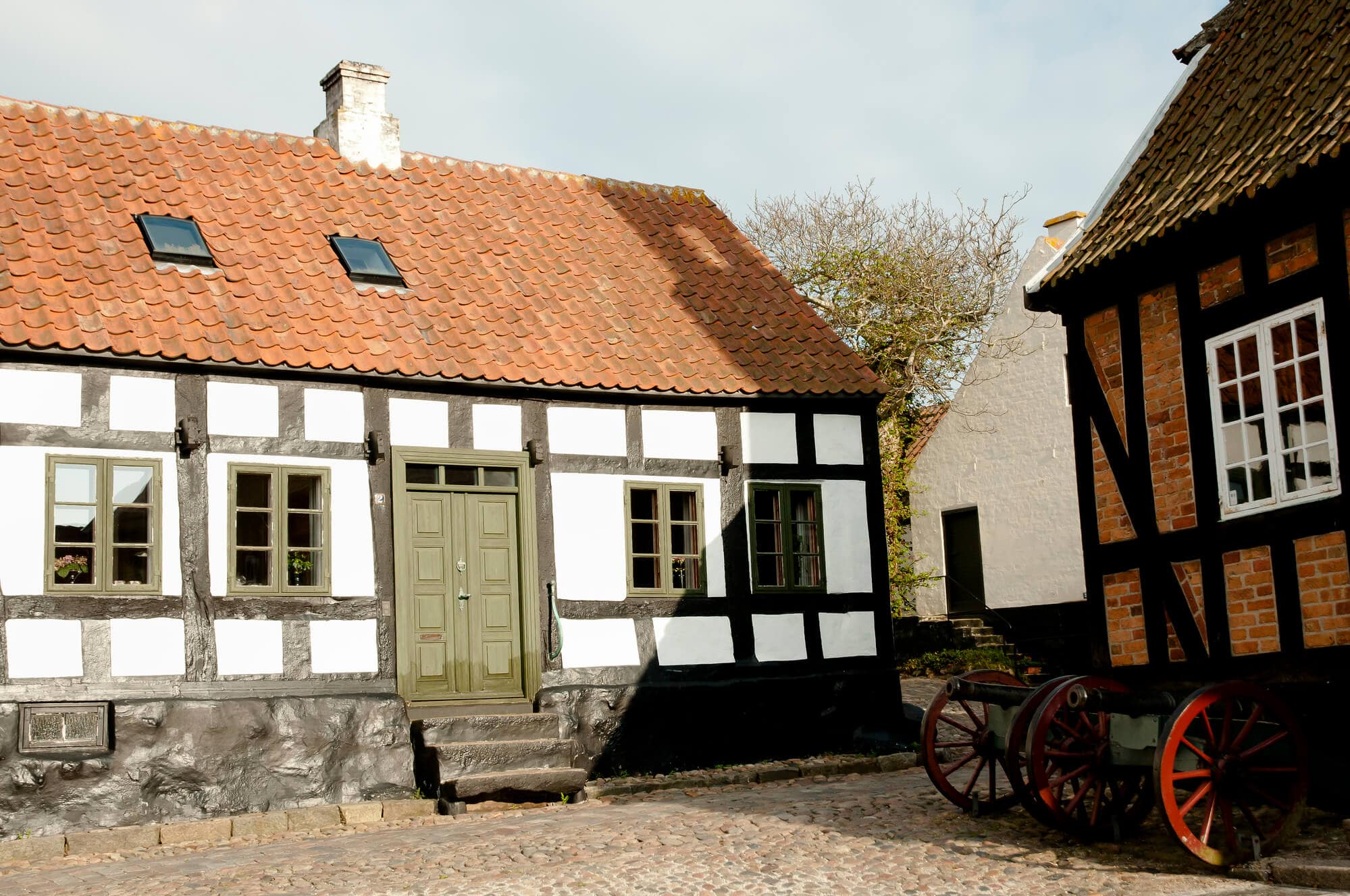 Old typical Danish half-timbered houses with orange roofs in Ebeltoft, the perfect day trip from Aarhus.