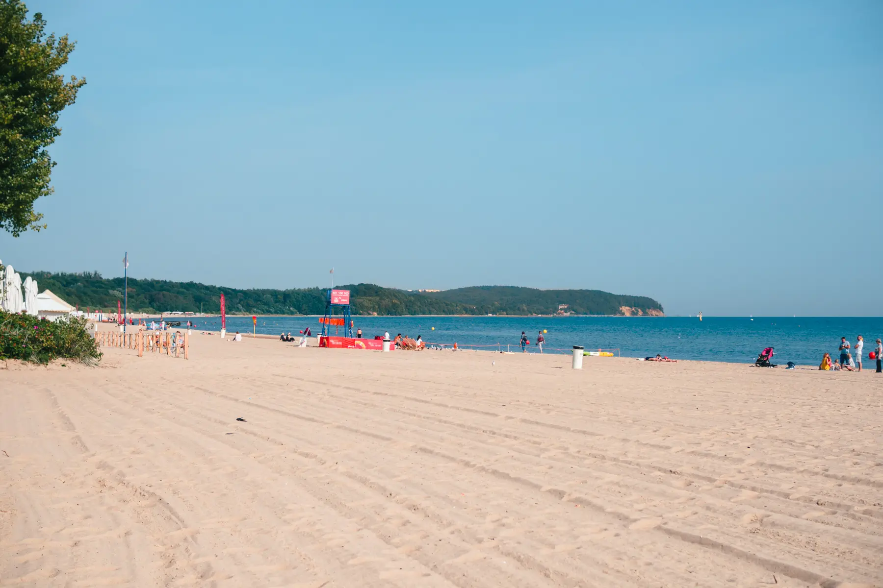 A vast light beige beach with a few people and blue skies in Sopot, during a 2-day itinerary in Gdansk. 