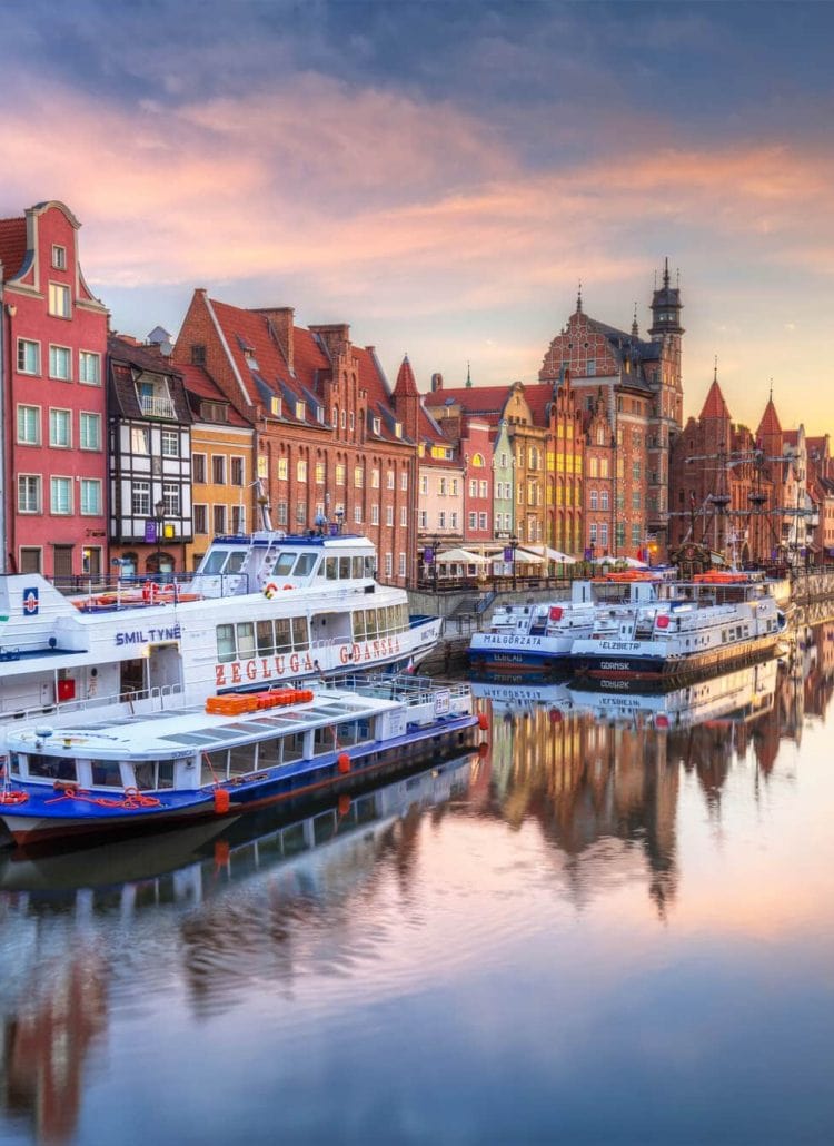 Gdansk river, with boats and colorful buildings at sunset. A must in any 2 day Gdansk itinerary