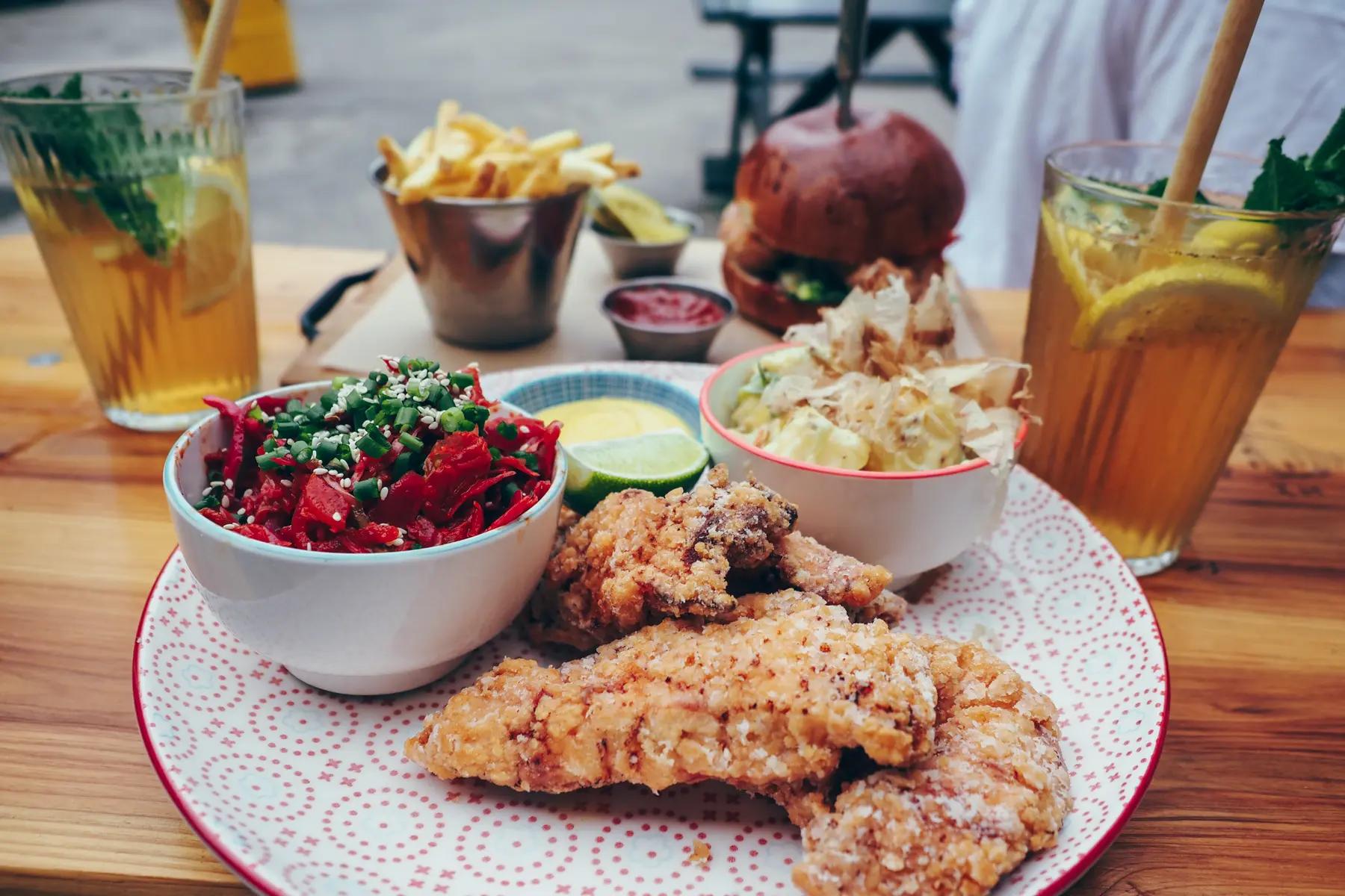 Korean fried chicken on a plate with honey mustard, kimchi and red potato salat, one of the best places for brunch during 2 days in Gdansk.