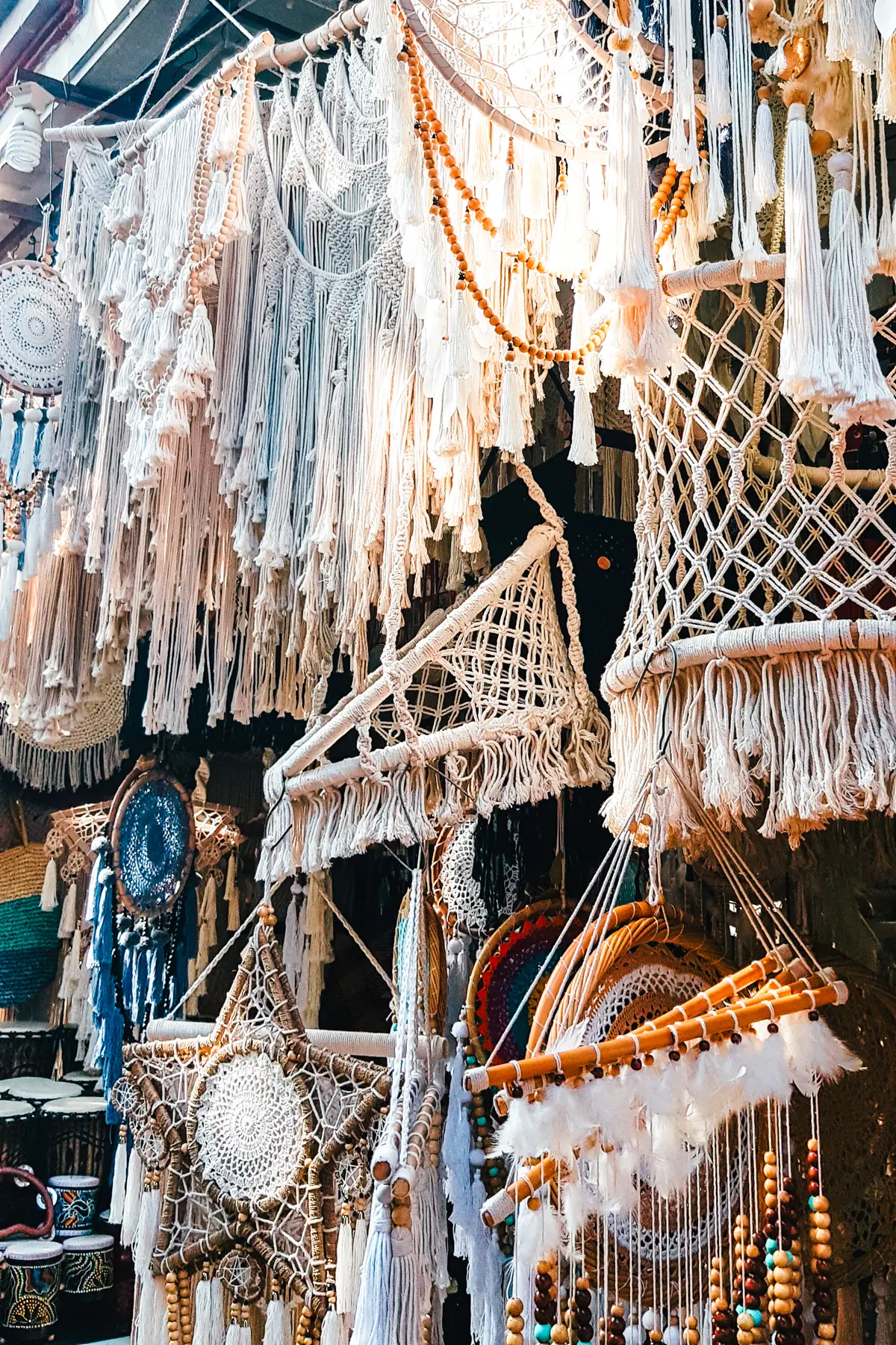 Close up of white macrame wall hangers at Ubud Art Market in Bali.