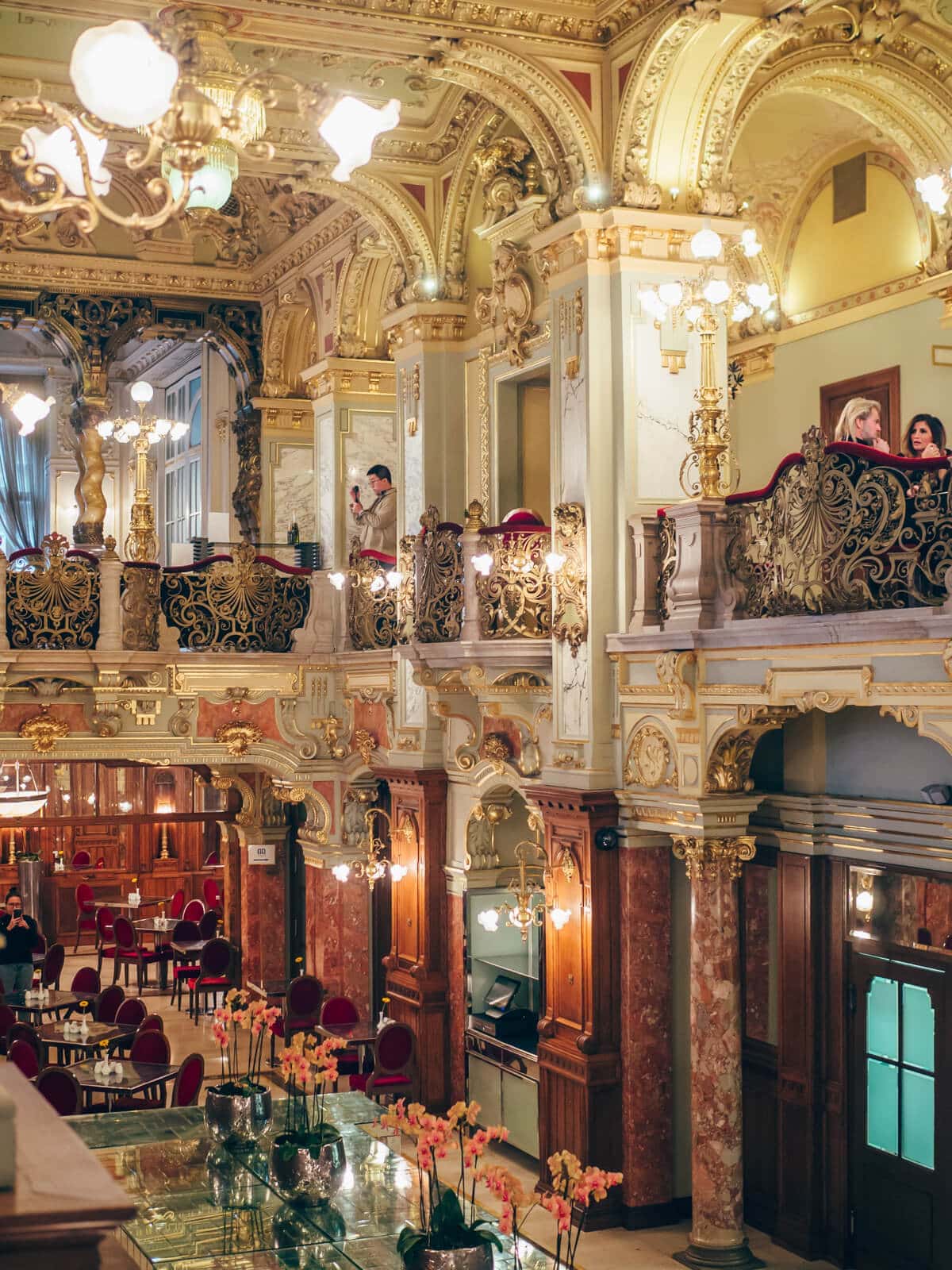 Inside the ornate New York Café in Budapest, decorated with chandeliers, gold leaf and red velvet.