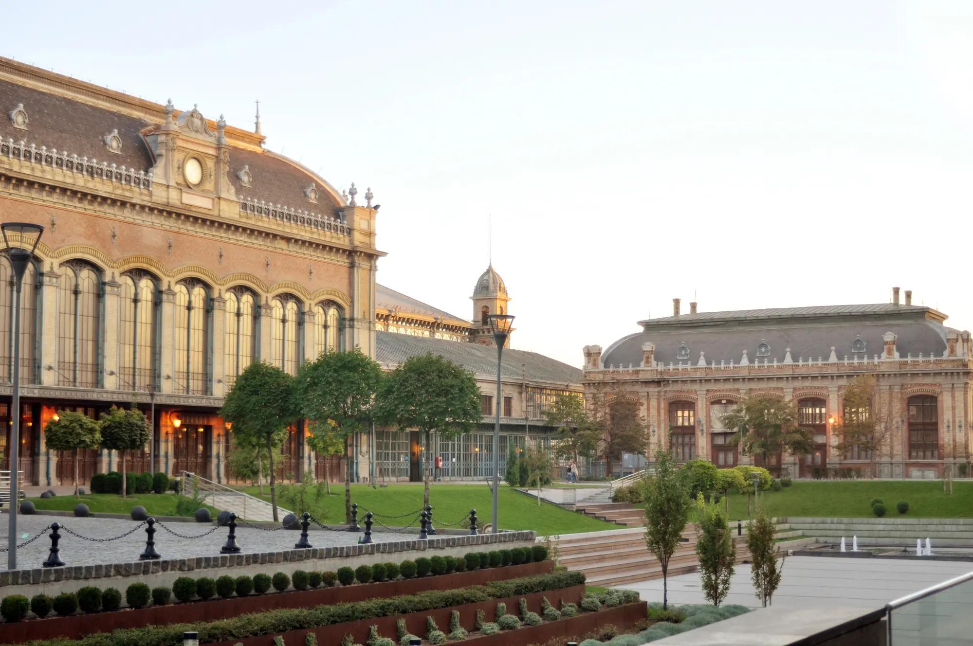 Large old world Nyugati train station with a manicured garden in front, one of the best Instagram spots in Budapest.